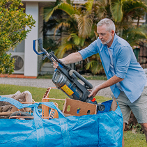 Man loading items into FlexiSkip